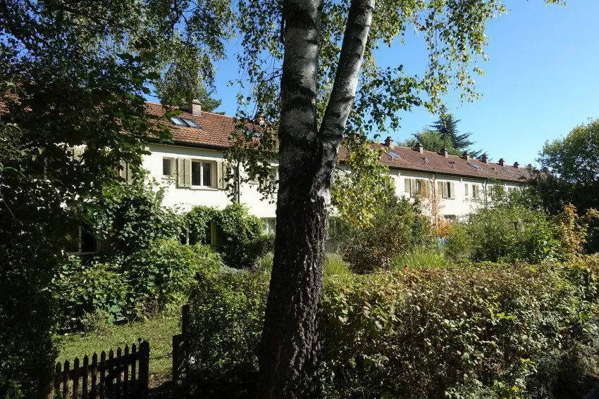 Reihen-Einfamilienhaus der FGZ-Siedlung Grossalbis (Etappe 8). Sichtbar sind Häuser und viel Garten.